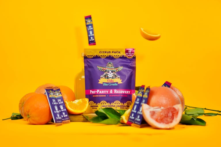 Citrus Park product display with oranges, grapefruits, and purple candy boxes on a bright yellow background